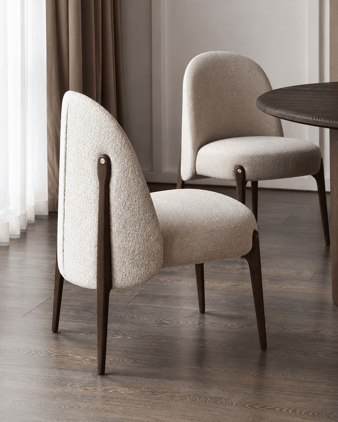NORA premium upholstered dining armchair with tall curved cream back, padded seat and dark walnut wooden frame.